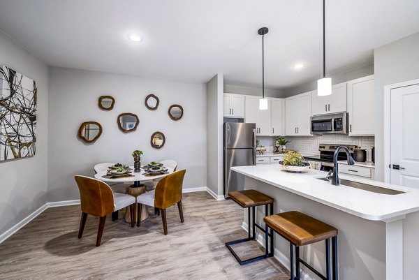 Modern kitchen with granite countertops at River Oaks Landing Apartments