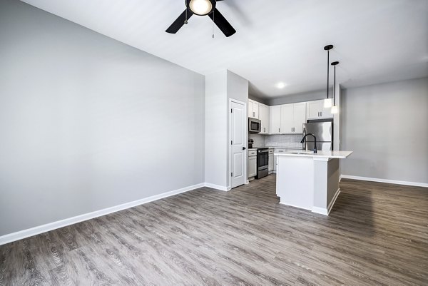 Cozy living room with modern decor and ample natural light at River Oaks Landing Apartments