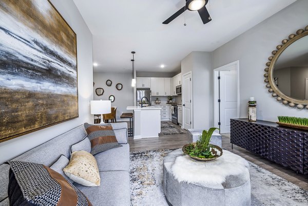 Bright living room with contemporary decor in River Oaks Landing Apartments, offering luxury living near key amenities and attractions