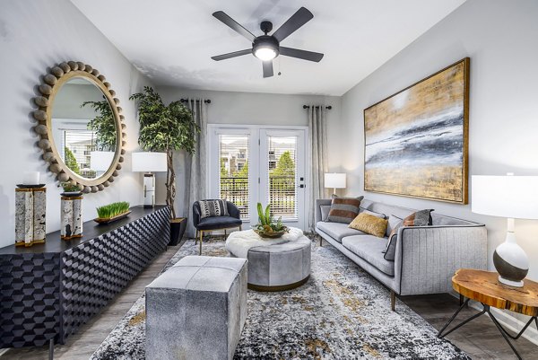 Spacious living room with modern decor and natural lighting in River Oaks Landing Apartments