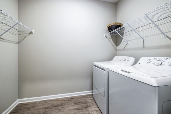 Laundry room with modern appliances at River Oaks Landing Apartments