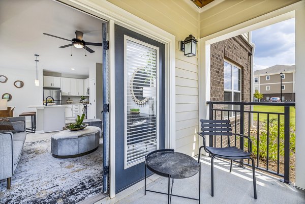 Spacious outdoor patio at River Oaks Landing Apartments, featuring modern seating and garden views