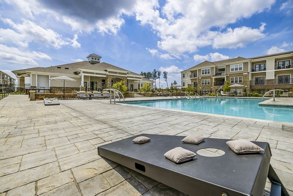Outdoor pool with lounge chairs at River Oaks Landing Apartments offering luxury living facilities