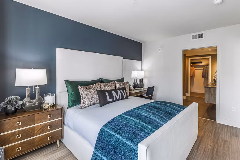Bedroom featuring modern dÃ©cor and large windows at Landsby Apartments