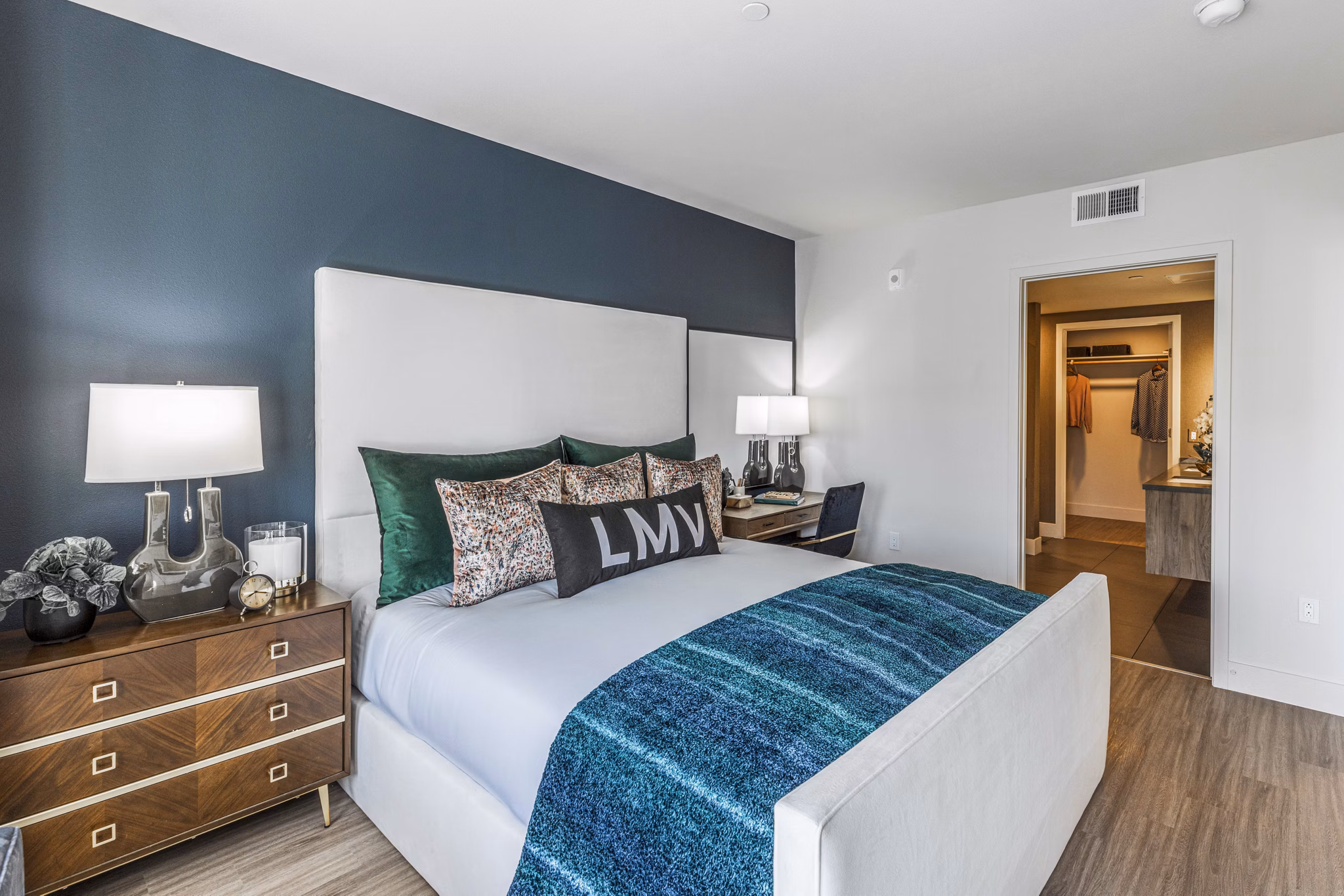 Bedroom featuring modern dÃ©cor and large windows at Landsby Apartments