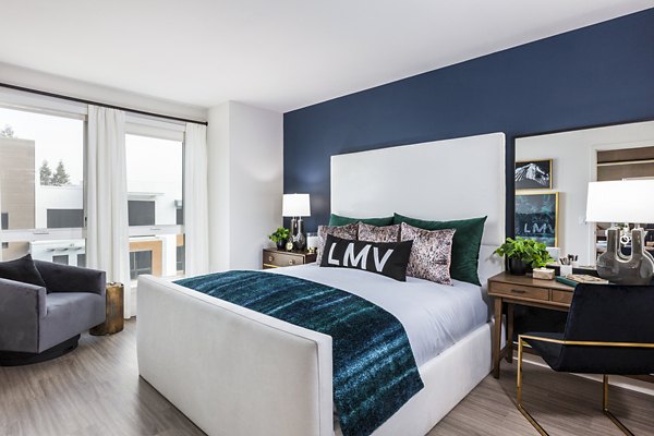 Cozy bedroom with elegant decor at Landsby Apartments, featuring modern furnishings and warm lighting for a luxurious living experience
