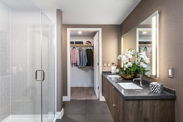 Bathroom with modern fixtures and elegant tile in Landsby Apartments
