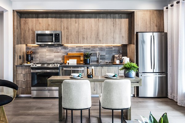 Dining room with modern kitchen appliances at Landsby Apartments