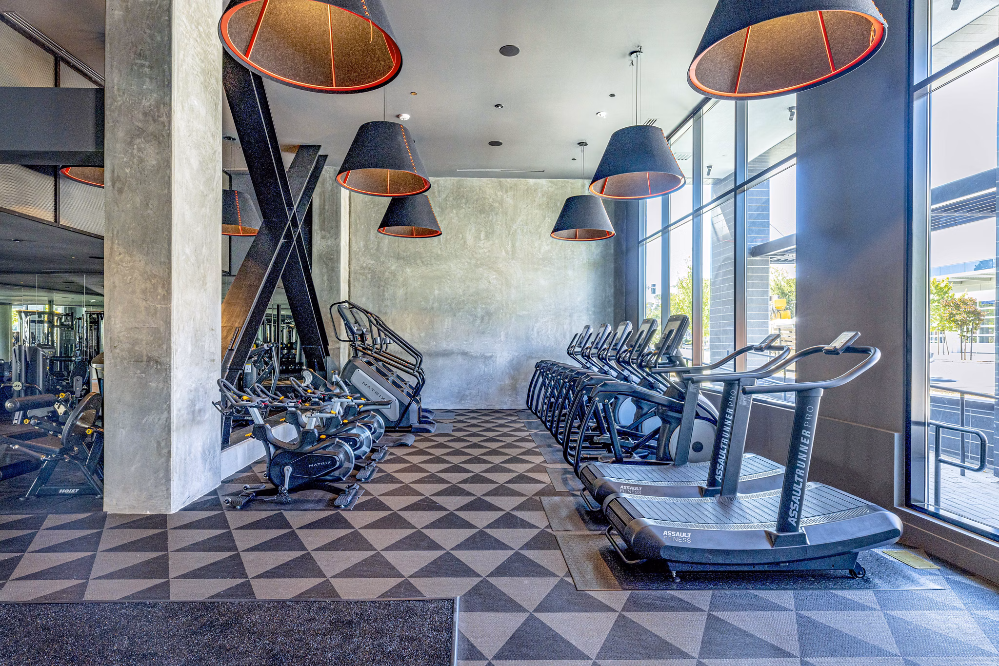 State-of-the-art fitness center featuring modern equipment at Landsby Apartments