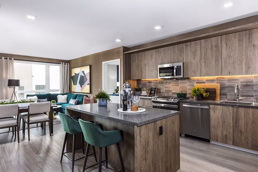 Modern kitchen with sleek countertops and stainless steel appliances in Landsby Apartments