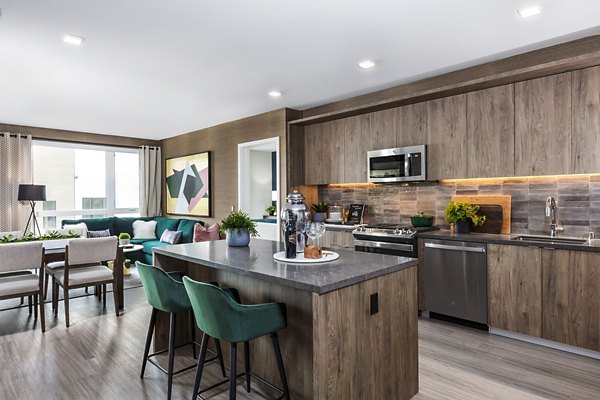 Modern kitchen with sleek countertops and stainless steel appliances in Landsby Apartments