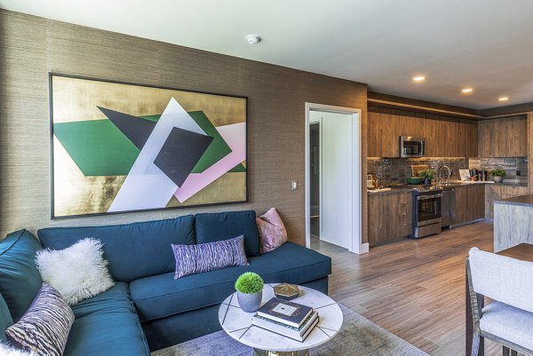 Modern living room with Scandinavian design at Landsby Apartments, featuring sleek furniture and natural light