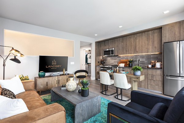 Contemporary living room with sleek furniture and natural light at Landsby Apartments