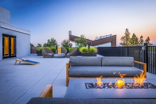 Landsby Apartments: Cozy outdoor patio with fire pit perfect for entertaining and relaxation