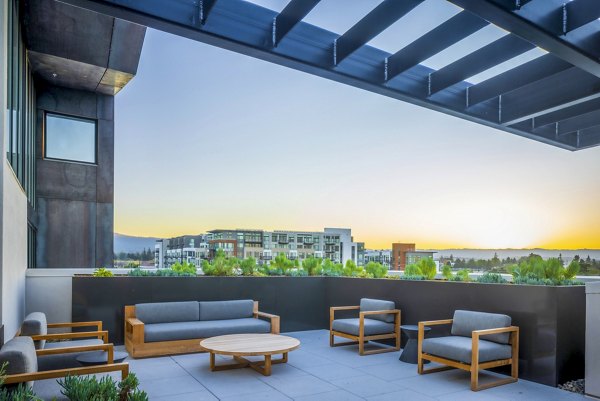 Landsby Apartments: Cozy patio with outdoor seating and lush greenery views