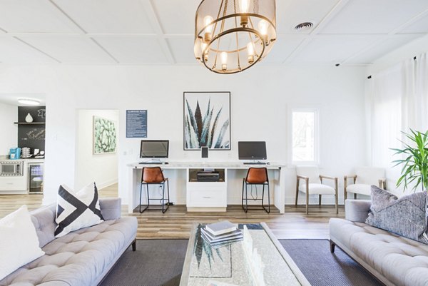 Avana Collins Creek: Modern business center with sleek workstations and natural lighting at luxury apartments in Greystar community