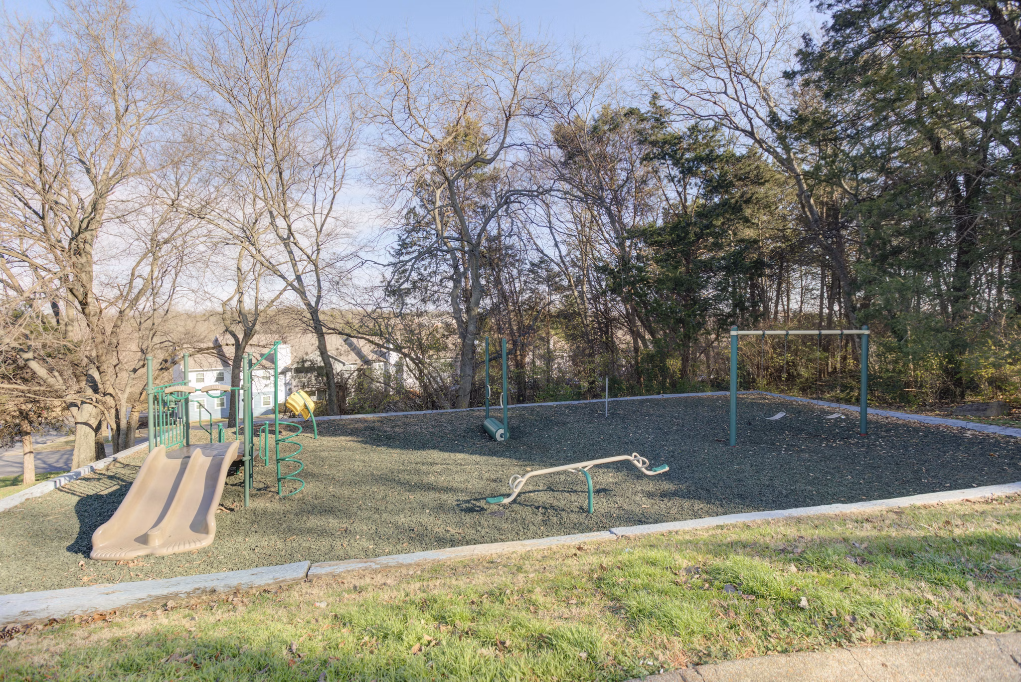 Modern playground with vibrant equipment at Avana Collins Creek Apartments, perfect for family fun and outdoor activities