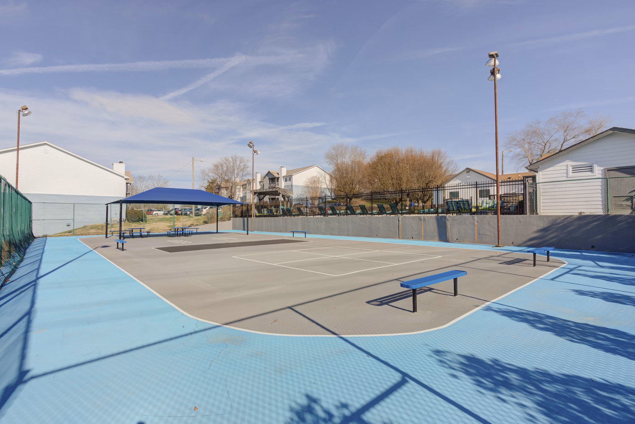 Outdoor sport court for basketball and tennis at Avana Collins Creek Apartments offering recreational activities in a luxury setting