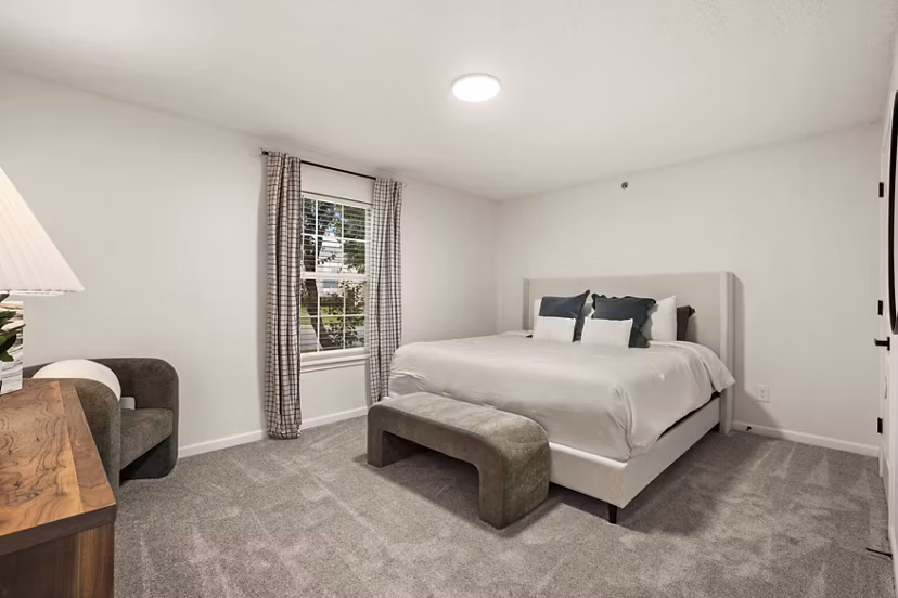 Bedroom featuring elegant decor and large windows at Avana South Oaks Apartments