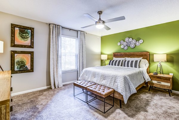 Bedroom featuring elegant decor and large windows at Avana South Oaks Apartments