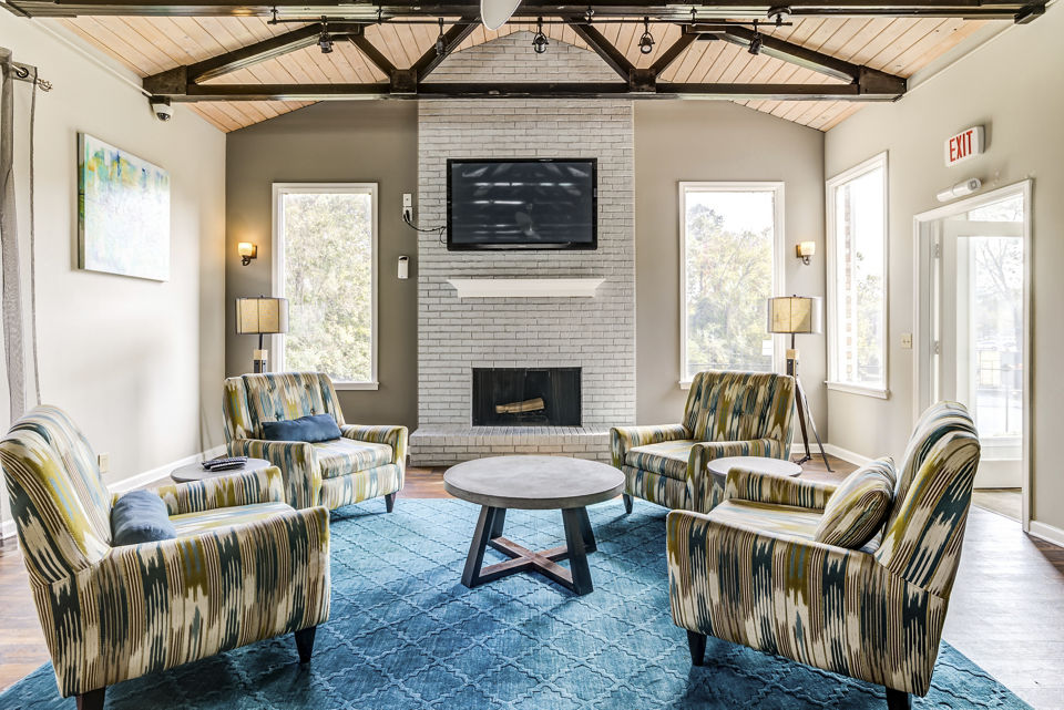Clubhouse/lobby with modern seating and lighting at Avana South Oaks Apartments