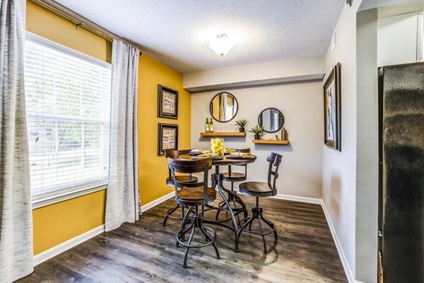 Dining room with elegant lighting and modern table setting at Avana South Oaks Apartments, luxury living by Greystar