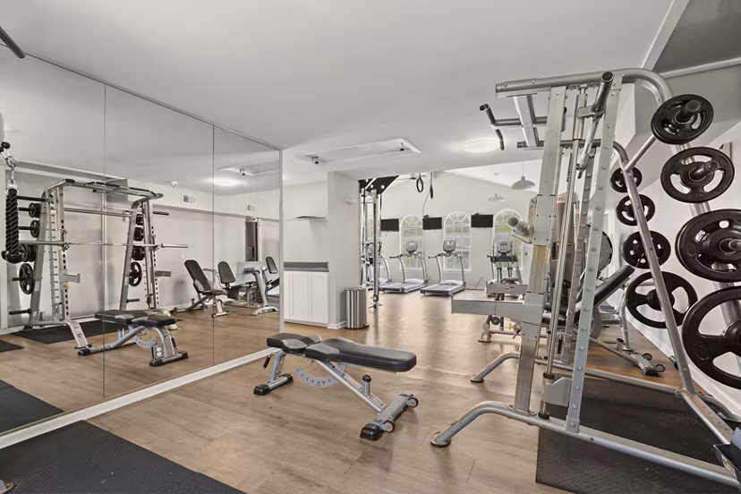 Fully-equipped fitness center with modern workout machines at Avana South Oaks Apartments