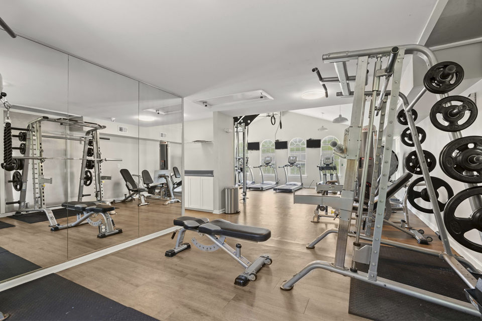 Fully-equipped fitness center with modern workout machines at Avana South Oaks Apartments