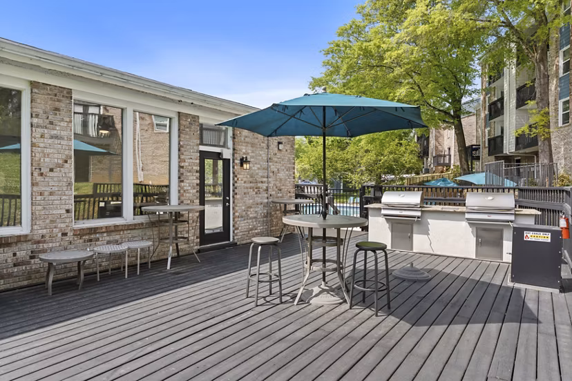 Inviting fire pit and grill area at Avana South Oaks Apartments, perfect for outdoor gatherings and relaxation