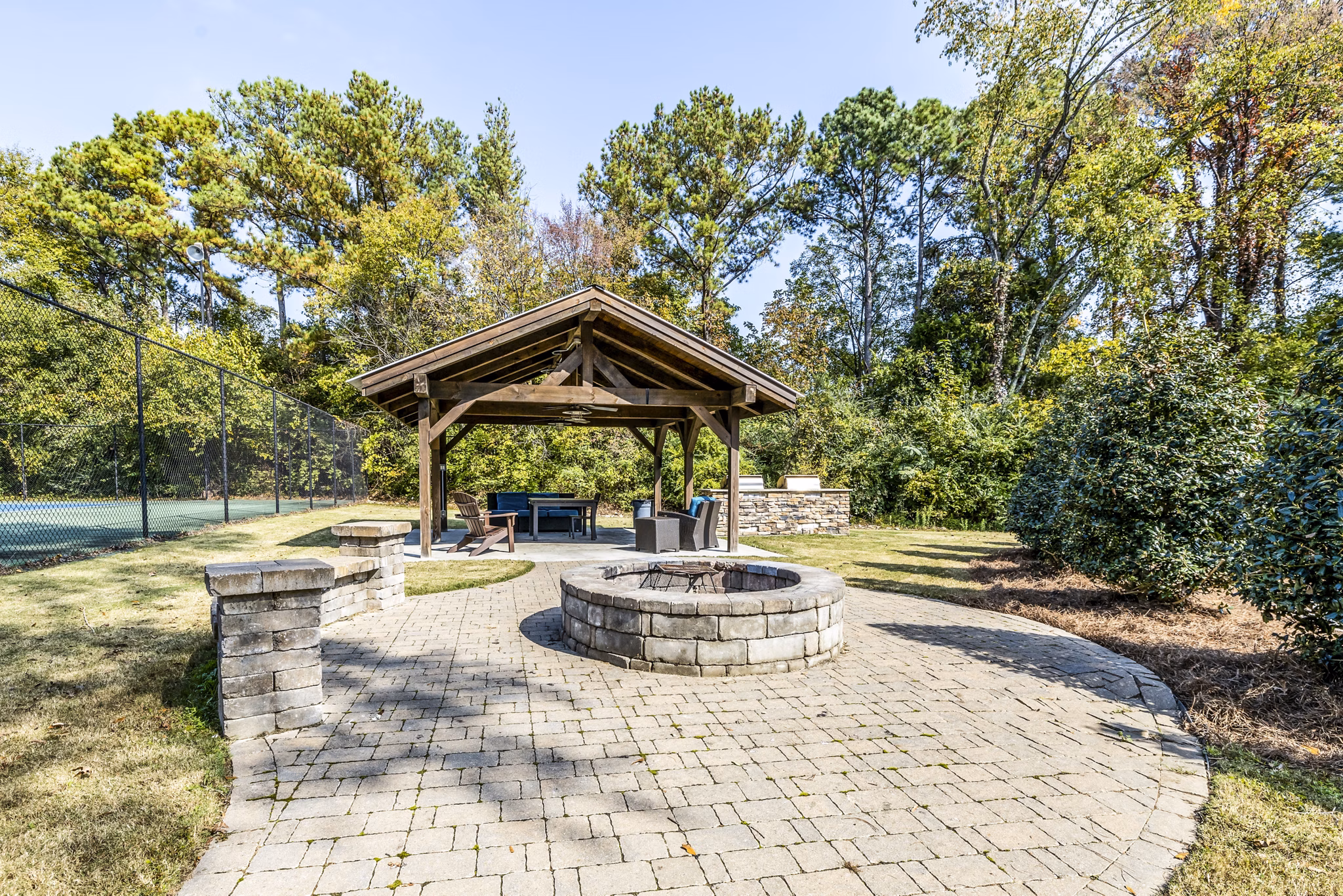 Inviting fire pit and grill area at Avana South Oaks Apartments, perfect for outdoor gatherings and relaxation