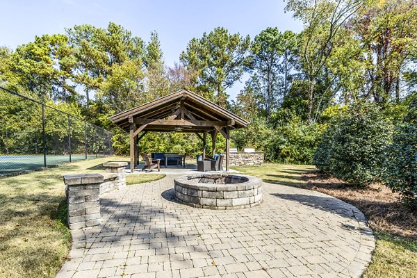 Inviting fire pit and grill area at Avana South Oaks Apartments, perfect for outdoor gatherings and relaxation