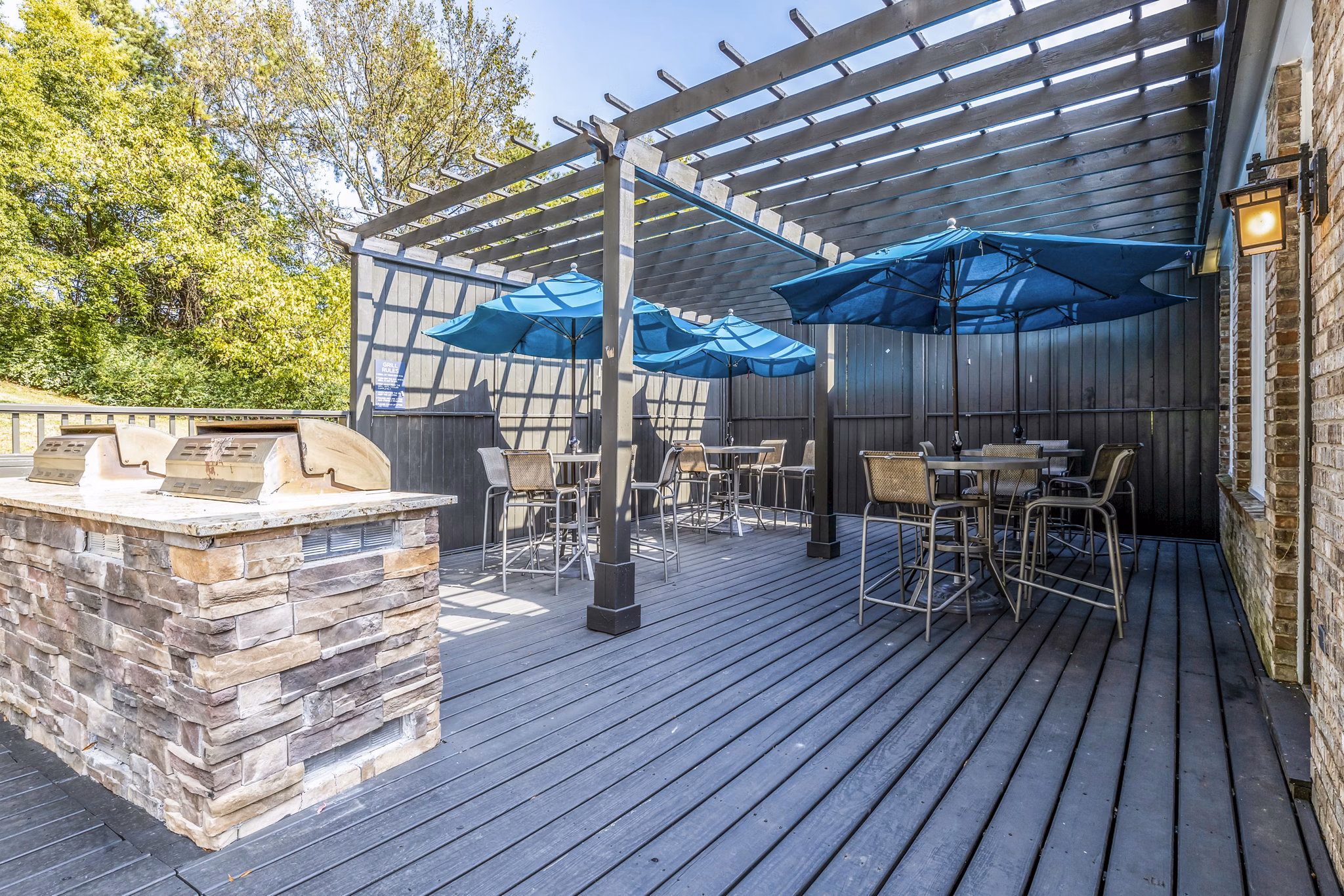 Grill area with seating at Avana South Oaks Apartments patio