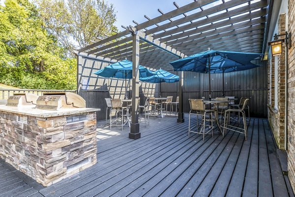 Grill area with seating at Avana South Oaks Apartments patio