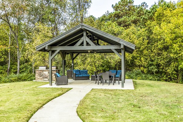 Outdoor grilling area with modern seating at Avana South Oaks Apartments, ideal for gatherings and leisure activities