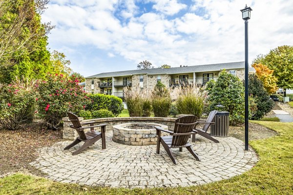 Fire pit patio at Avana South Oaks Apartments offering cozy outdoor seating and ambient lighting for evening relaxation