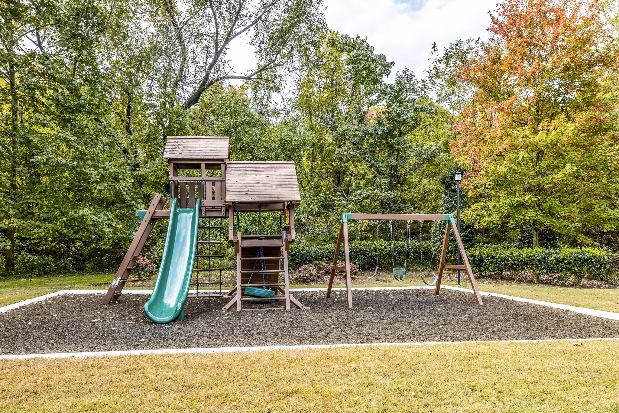Colorful playground set at Avana South Oaks Apartments, featuring slides and swings for resident enjoyment