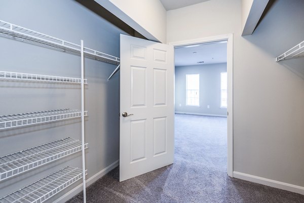 Walk-in closet with ample shelving in bedroom at Pinnacle at Town Center Apartments