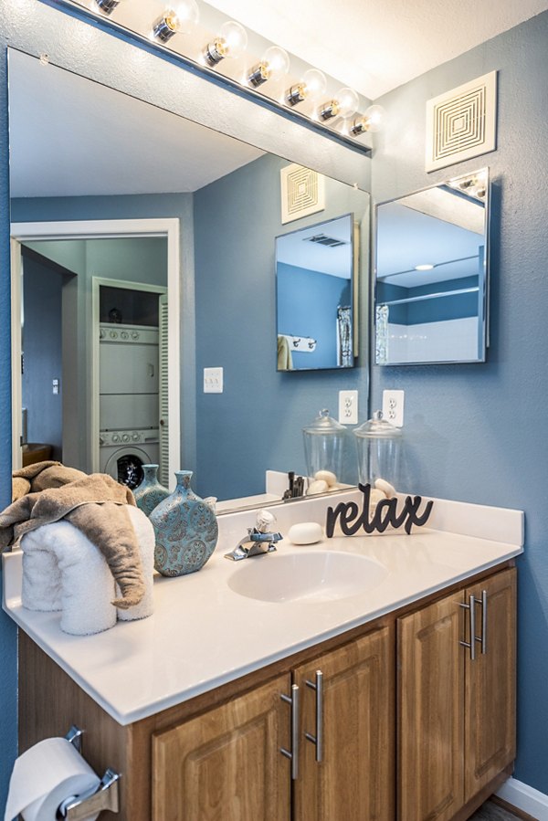 Modern bathroom featuring sleek fixtures and ample storage at Pinnacle at Town Center Apartments
