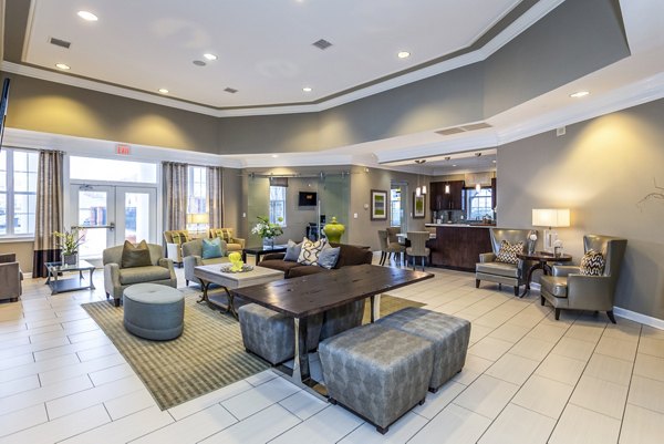 Clubhouse lobby featuring elegant design and seating at Pinnacle at Town Center Apartments