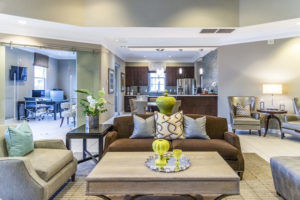 Clubhouse lobby with plush seating and modern decor at Pinnacle at Town Center Apartments