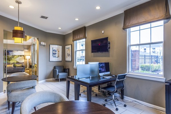 Clubhouse business center at Pinnacle at Town Center Apartments with modern workstations and meeting space