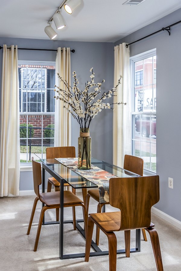 Dining room with elegant chandelier and large table at Pinnacle at Town Center Apartments