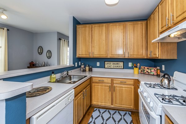 Kitchens with contemporary design featuring modern appliances at Pinnacle at Town Center Apartments