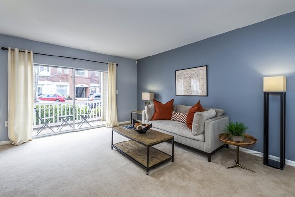 Contemporary living room with plush seating and natural light at Pinnacle at Town Center Apartments in Greystar community