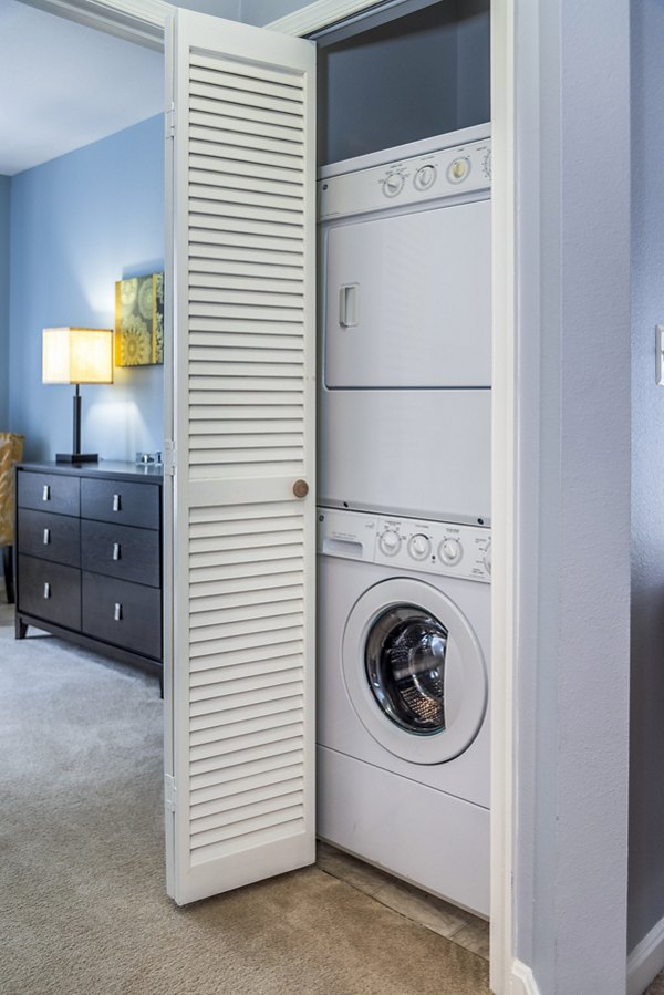 Laundry room equipped with modern appliances at Pinnacle at Town Center Apartments