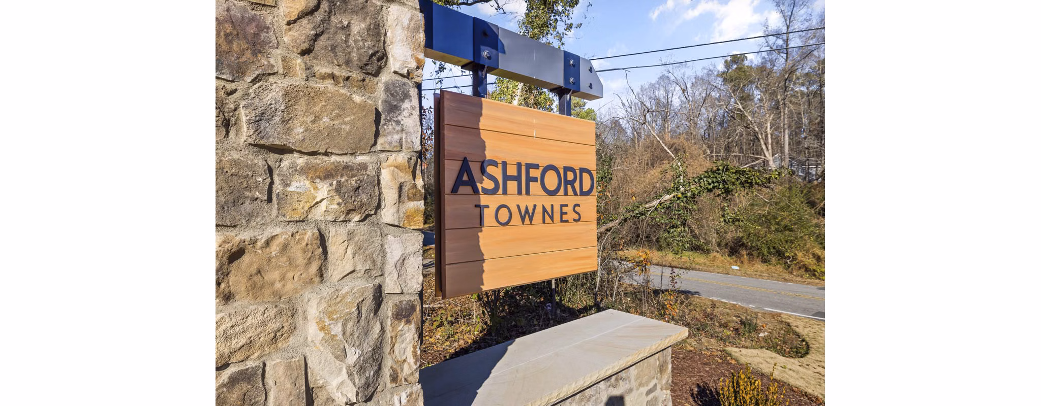 Ashford Townes Apartments: Elegant signage marking luxury living amidst serene surroundings