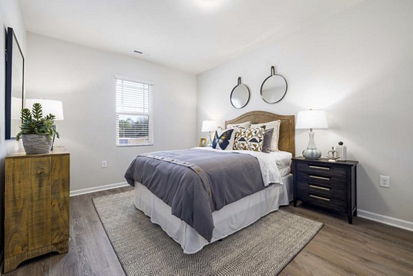 Cozy bedroom with modern decor at Ashford Townes Apartments, featuring soft lighting and ample space for relaxation