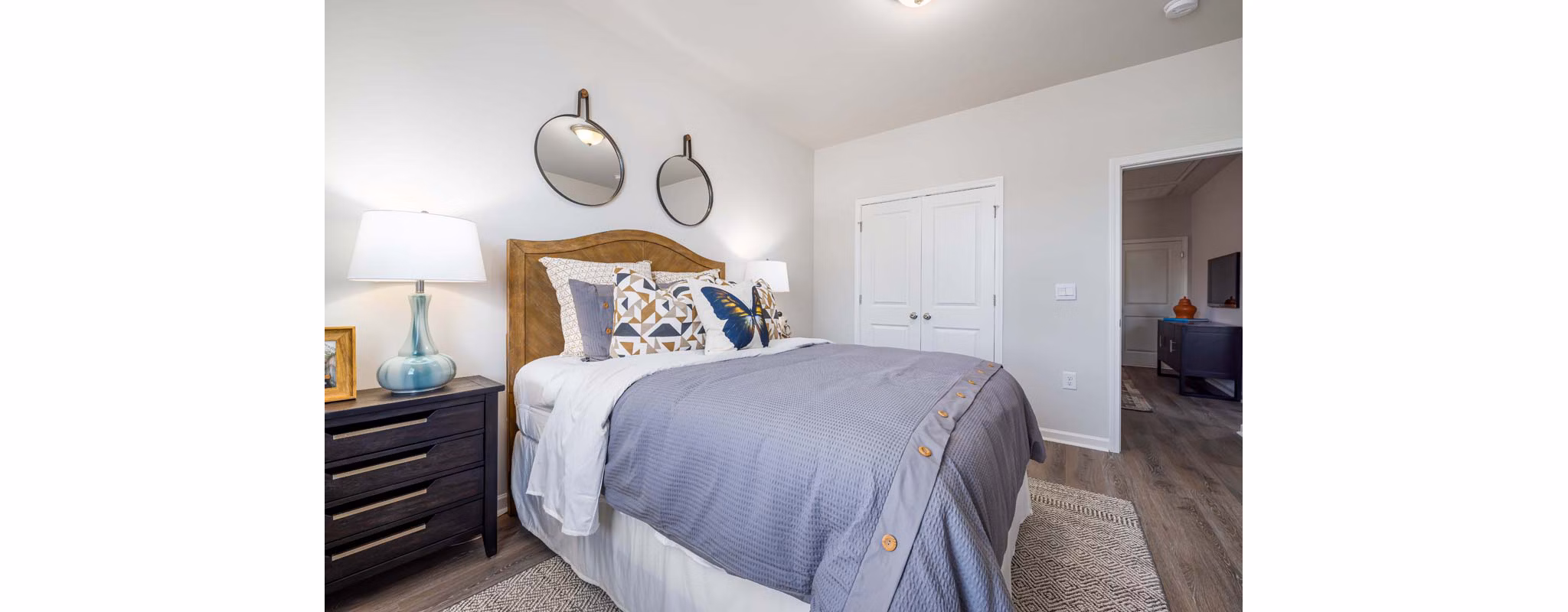 Cozy bedroom with modern furnishings in Ashford Townes Apartments, offering luxury living in a comfortable setting
