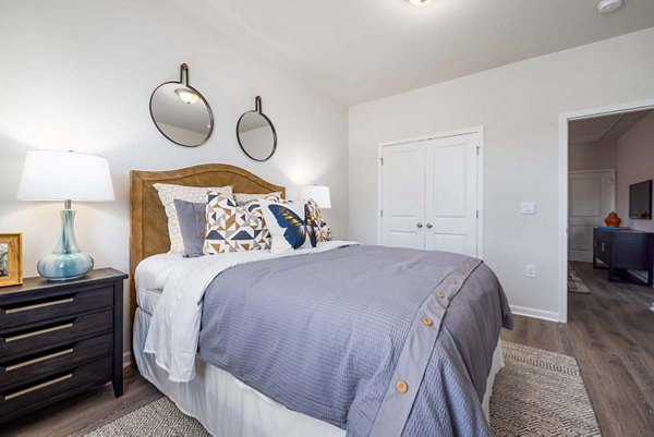 Cozy bedroom with modern furnishings in Ashford Townes Apartments, offering luxury living in a comfortable setting