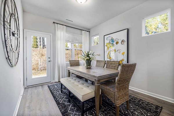 Dining area with modern fixtures and cozy seating at Ashford Townes Apartments Luxurious ambiance in this Greystar-managed community